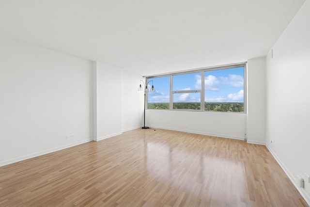 7234 W N Ave Unit 1610, Elmwood Park, IL 60707 - unfurnished room with light wood-style floors and baseboards