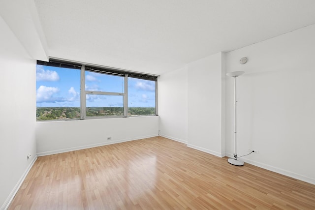7234 W N Ave Unit 1610, Elmwood Park, IL 60707 - spare room with light wood-style floors and a smoke detector