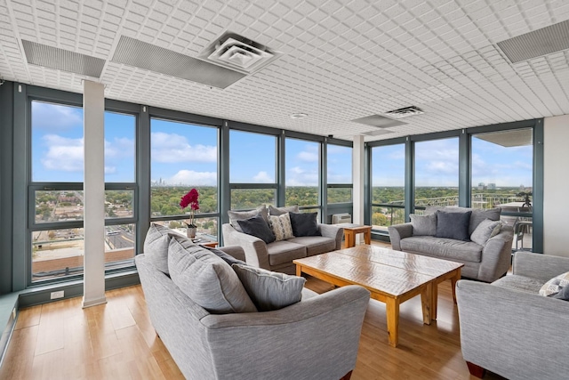 7234 W N Ave Unit 1610, Elmwood Park, IL 60707 - living room featuring expansive windows, light wood-style flooring, and healthy amount of natural light
