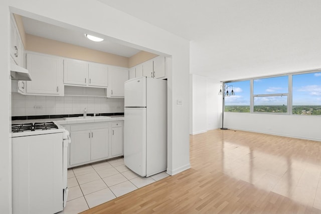 7234 W N Ave Unit 1610, Elmwood Park, IL 60707 - kitchen with white appliances, under cabinet range hood, tile counters, white cabinetry, and light wood-style floors