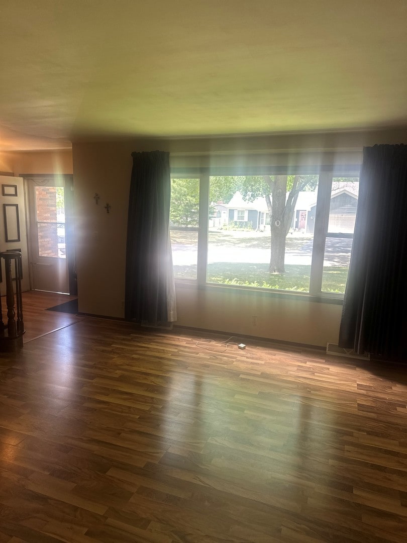 154 Howard Ave, East Dundee, IL 60118 - empty room featuring plenty of natural light and dark wood finished floors
