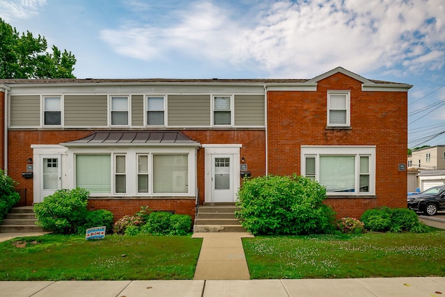 5641 W Carmen Ave, Chicago, IL 60630 - view of property with brick siding, a standing seam roof, and a front yard