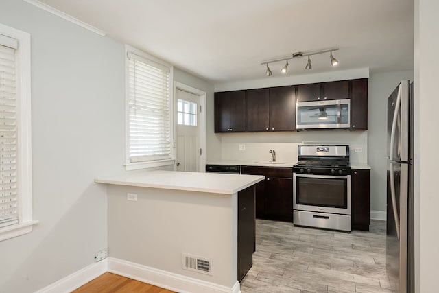 5641 W Carmen Ave, Chicago, IL 60630 - kitchen with appliances with stainless steel finishes, light wood-style flooring, dark brown cabinetry, and light countertops