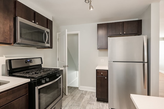 5641 W Carmen Ave, Chicago, IL 60630 - kitchen featuring appliances with stainless steel finishes, light wood-style floors, light countertops, and dark brown cabinets