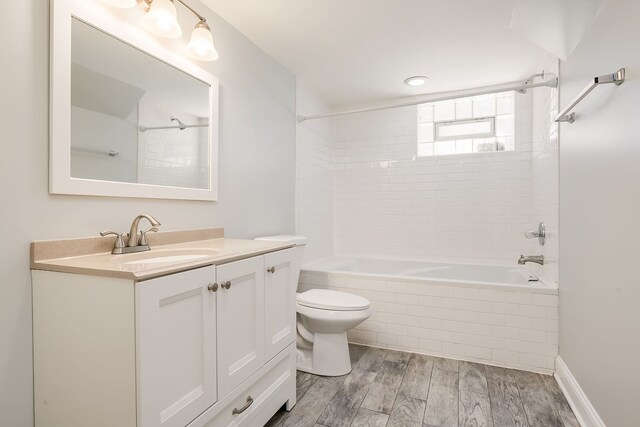 5641 W Carmen Ave, Chicago, IL 60630 - full bath featuring tiled shower / bath, vanity, and wood finished floors