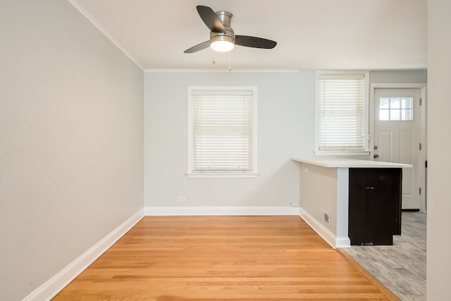 5641 W Carmen Ave, Chicago, IL 60630 - unfurnished dining area featuring light wood finished floors, a ceiling fan, and crown molding