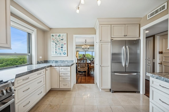 3470 N Lake Shore Dr Unit 9Bc, Chicago, IL 60657 - kitchen with stainless steel appliances, a chandelier, stone counters, and cream cabinetry