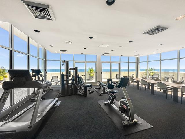 3470 N Lake Shore Dr Unit 9Bc, Chicago, IL 60657 - exercise room featuring floor to ceiling windows, a water view, and healthy amount of natural light