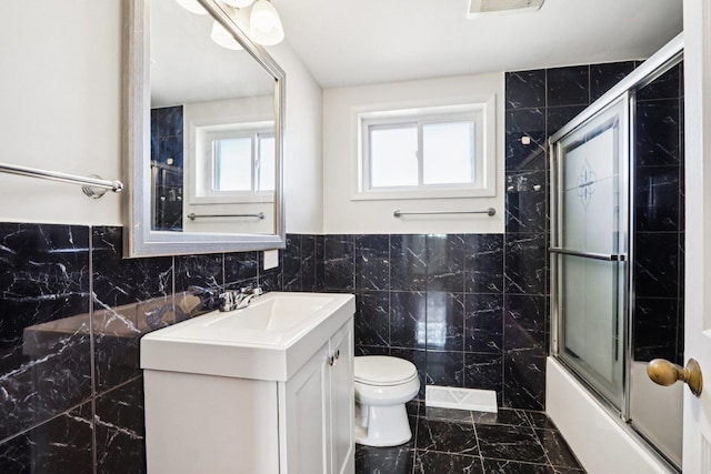 8666 Gregory Ln Unit C, Des Plaines, IL 60016 - full bath featuring tile walls, vanity, shower / bath combination with glass door, and marble finish flooring
