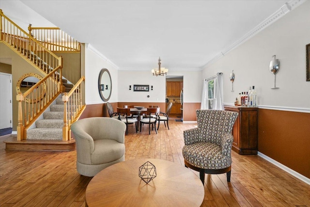 33 Sarah Dr, Crystal Lake, IL 60014 - living room featuring stairs, hardwood / wood-style floors, a chandelier, ornamental molding, and a wainscoted wall