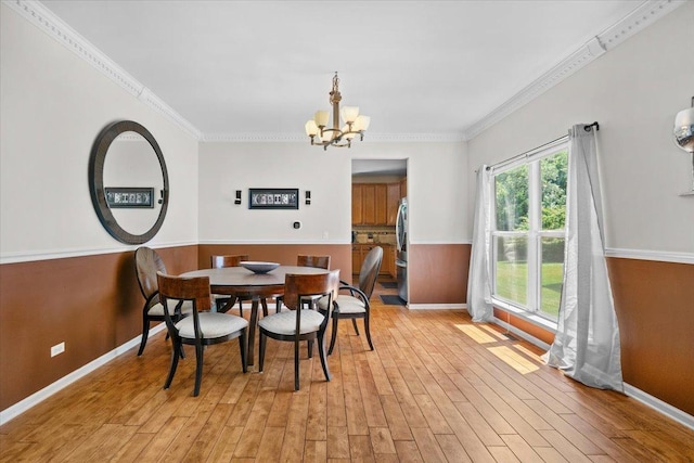 33 Sarah Dr, Crystal Lake, IL 60014 - dining space featuring a chandelier, light wood-style flooring, and ornamental molding