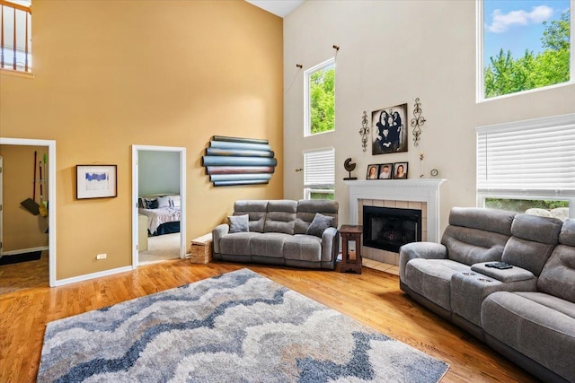 33 Sarah Dr, Crystal Lake, IL 60014 - living area with a towering ceiling, wood finished floors, and a tiled fireplace