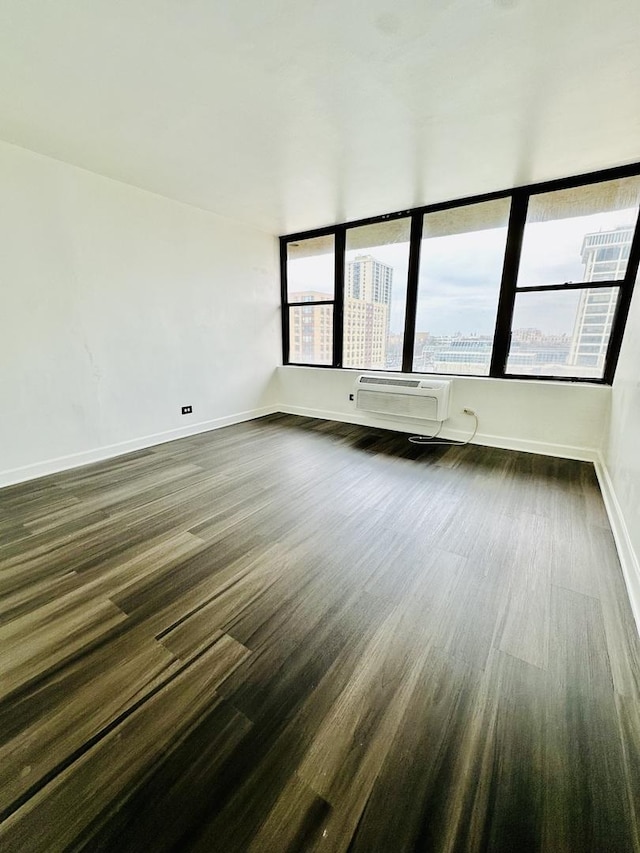 345 E Eastgate Pl Unit 602, Chicago, IL 60616 - empty room featuring dark wood finished floors and a wall mounted air conditioner