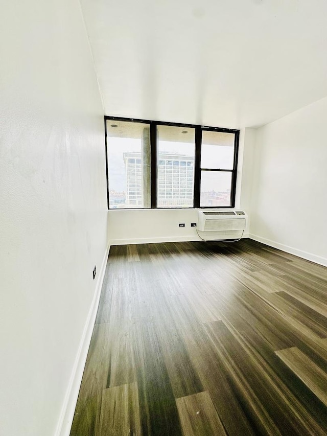 345 E Eastgate Pl Unit 602, Chicago, IL 60616 - empty room featuring healthy amount of natural light, a wall unit AC, and wood finished floors