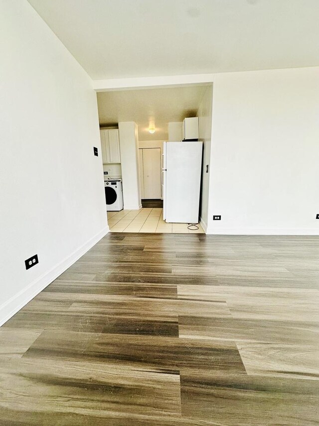 345 E Eastgate Pl Unit 602, Chicago, IL 60616 - unfurnished living room with washer / dryer and baseboards