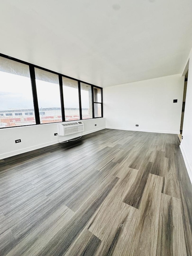 345 E Eastgate Pl Unit 602, Chicago, IL 60616 - unfurnished living room featuring wood finished floors and a wall mounted AC