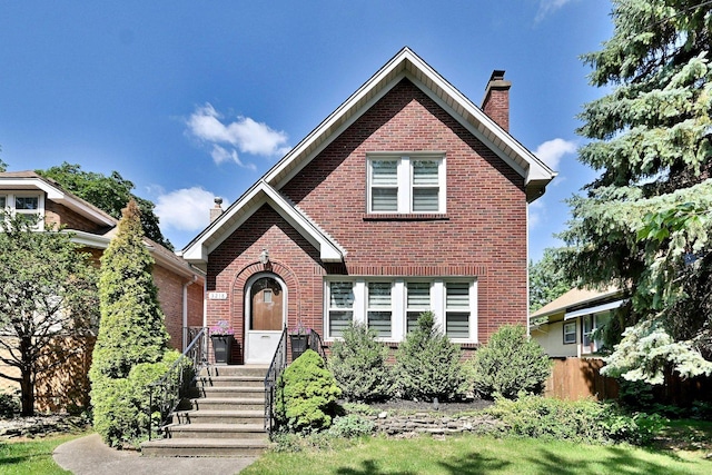 3218 Scoville Ave, Berwyn, IL 60402 - tudor-style house featuring brick siding and a chimney