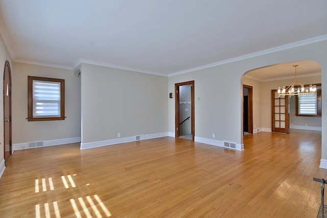 3218 Scoville Ave, Berwyn, IL 60402 - unfurnished room with a chandelier, arched walkways, healthy amount of natural light, light wood-type flooring, and crown molding