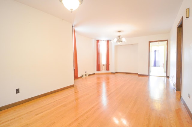 4048 N Marmora Ave, Chicago, IL 60630 - unfurnished room featuring a chandelier and light wood-style floors