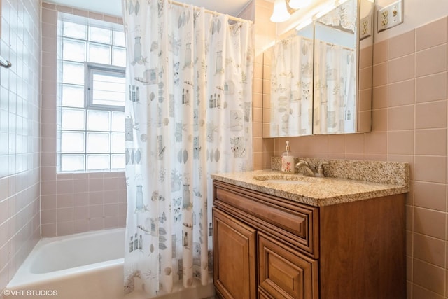 6919 N Overhill Ave, Chicago, IL 60631 - bathroom featuring vanity, shower / bathtub combination with curtain, and tile walls