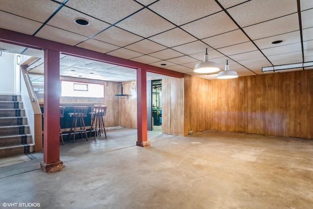 6919 N Overhill Ave, Chicago, IL 60631 - below grade area featuring stairs, wooden walls, a dry bar, and a drop ceiling