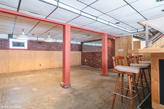 6919 N Overhill Ave, Chicago, IL 60631 - finished below grade area with a bar, wooden walls, and a drop ceiling