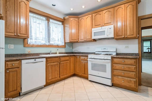 6919 N Overhill Ave, Chicago, IL 60631 - kitchen featuring white appliances, dark countertops, recessed lighting, brown cabinetry, and light tile patterned floors