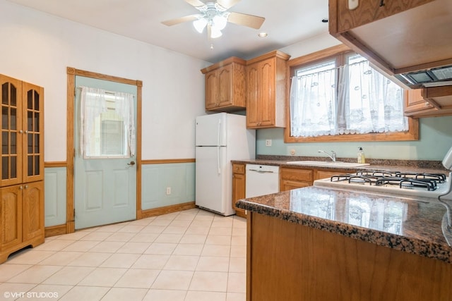 6919 N Overhill Ave, Chicago, IL 60631 - kitchen with white appliances, exhaust hood, ceiling fan, dark stone countertops, and a wainscoted wall