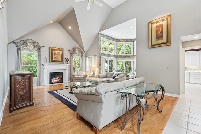 1806 Princeton Ct, Lake Forest, IL 60045 - living room with high vaulted ceiling, a ceiling fan, a glass covered fireplace, light wood finished floors, and recessed lighting