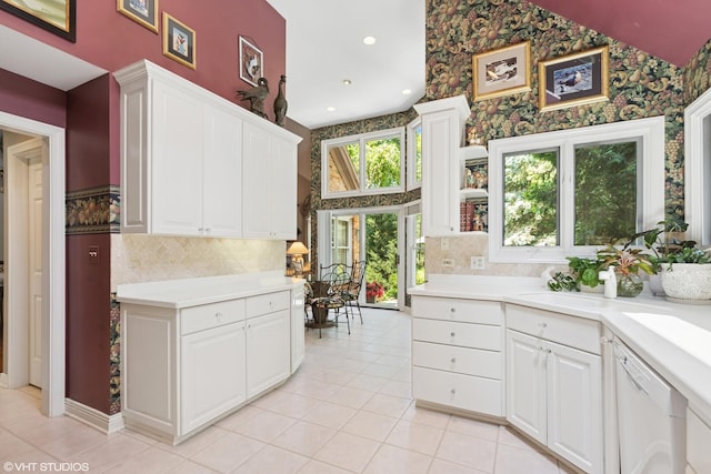 1806 Princeton Ct, Lake Forest, IL 60045 - kitchen with wallpapered walls, backsplash, dishwasher, white cabinetry, and light tile patterned flooring