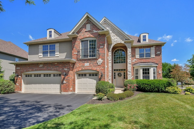 520 Meadowwood Ln, Oswego, IL 60543 - view of front of home with an attached garage, driveway, a front yard, brick siding, and a shingled roof