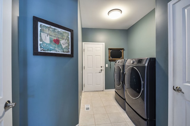 520 Meadowwood Ln, Oswego, IL 60543 - laundry room with washing machine and clothes dryer and light tile patterned flooring