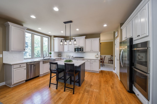 520 Meadowwood Ln, Oswego, IL 60543 - kitchen with appliances with stainless steel finishes, white cabinetry, light countertops, backsplash, and recessed lighting