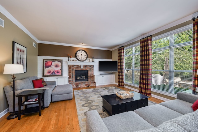 520 Meadowwood Ln, Oswego, IL 60543 - living room featuring crown molding, wood finished floors, and a fireplace