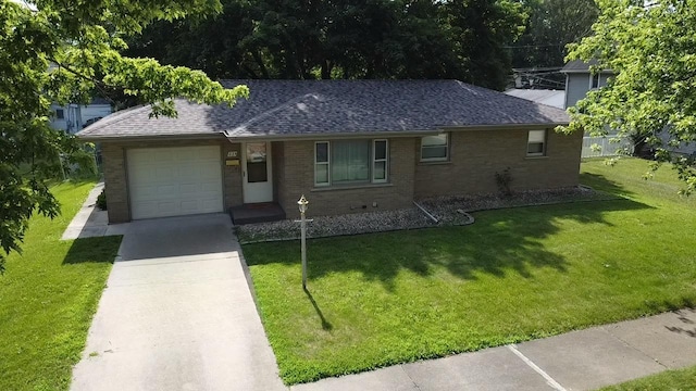 224 S Prairie Ave, Bradley, IL 60915 - ranch-style home with brick siding, roof with shingles, a garage, and a front yard