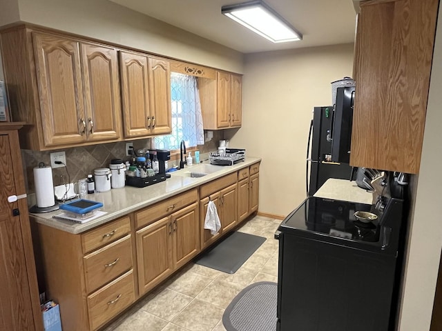 224 S Prairie Ave, Bradley, IL 60915 - kitchen featuring black electric range oven, light countertops, backsplash, and light tile patterned floors