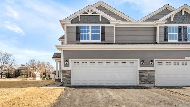 283 Charlestowne Lakes Dr, Saint Charles, IL 60174 - craftsman house with stone siding, a garage, and asphalt driveway