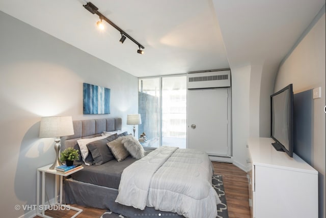 300 N State St Unit 3808, Chicago, IL 60654 - bedroom featuring dark wood-type flooring, a wall mounted AC, and baseboard heating
