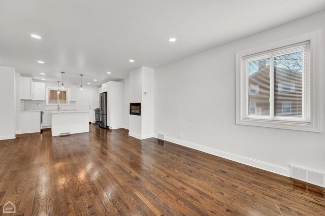 8559 S Drexel Ave, Chicago, IL 60619 - unfurnished living room with recessed lighting and dark wood-type flooring