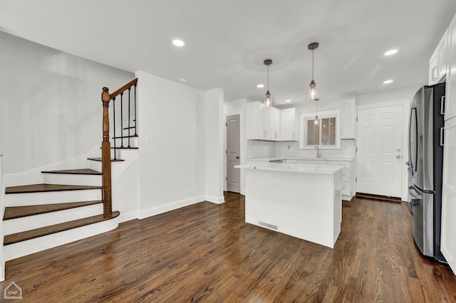 8559 S Drexel Ave, Chicago, IL 60619 - kitchen featuring freestanding refrigerator, light countertops, white cabinetry, a kitchen island, and dark wood-type flooring