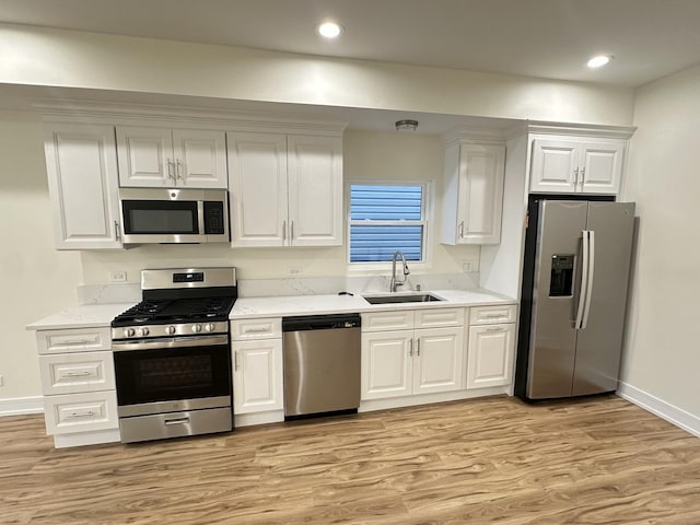 1325 S 50th Ct, Cicero, IL 60804 - kitchen with stainless steel appliances, light wood finished floors, white cabinets, recessed lighting, and light stone counters