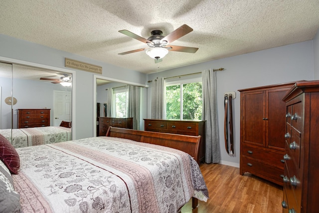 1380 Windjammer Ln, Hanover Park, IL 60133 - bedroom featuring light wood-style floors, a textured ceiling, and ceiling fan