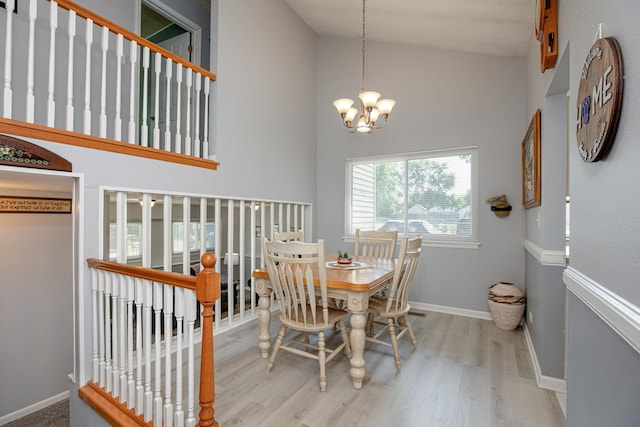 1380 Windjammer Ln, Hanover Park, IL 60133 - dining space featuring high vaulted ceiling, wood finished floors, and a chandelier