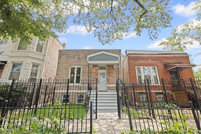 4025 W Adams St, Chicago, IL 60624 - view of front of house with a fenced front yard, stone siding, and a gate