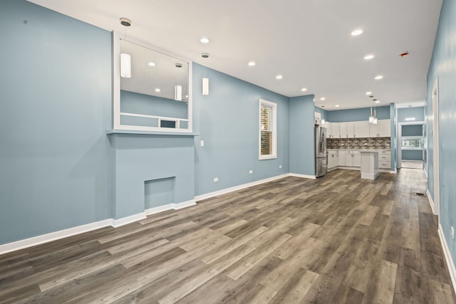4025 W Adams St, Chicago, IL 60624 - unfurnished living room with dark wood-type flooring, recessed lighting, and plenty of natural light