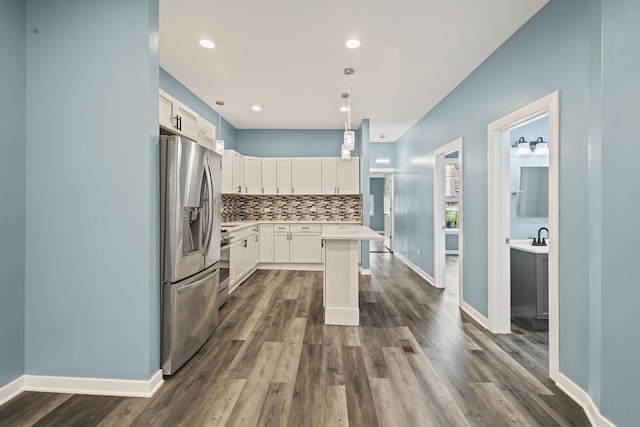 4025 W Adams St, Chicago, IL 60624 - kitchen with stainless steel appliances, decorative backsplash, light countertops, dark wood finished floors, and recessed lighting