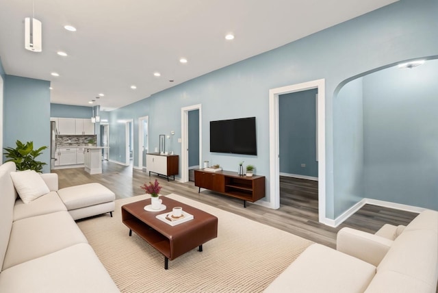 4025 W Adams St, Chicago, IL 60624 - living room featuring light wood-type flooring, arched walkways, and recessed lighting