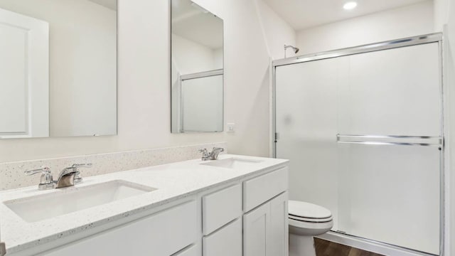 17319 Ulster Dr, Tinley Park, IL 60477 - full bathroom featuring a shower stall, double vanity, wood finished floors, and recessed lighting