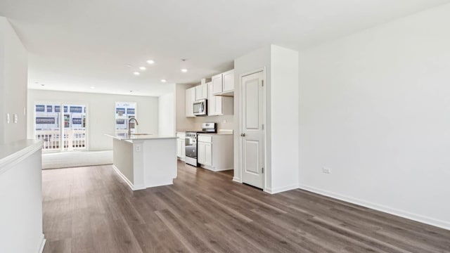 17319 Ulster Dr, Tinley Park, IL 60477 - kitchen with stainless steel appliances, dark wood-style flooring, a center island with sink, white cabinets, and recessed lighting