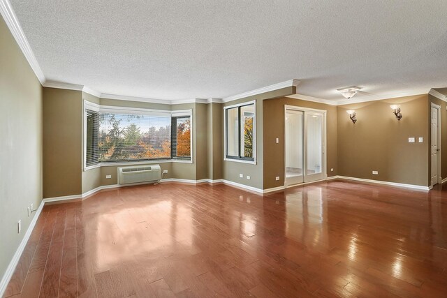 470 Fawell Blvd Unit 320, Glen Ellyn, IL 60137 - spare room with a textured ceiling, a wall mounted air conditioner, wood finished floors, and crown molding